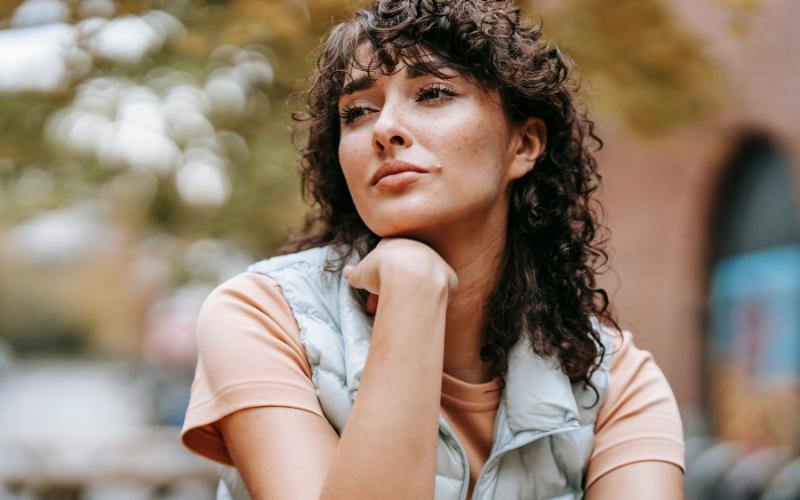 woman contemplating - sitting outside