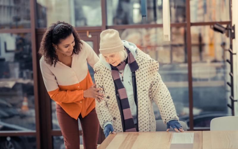 woman helping senior get up